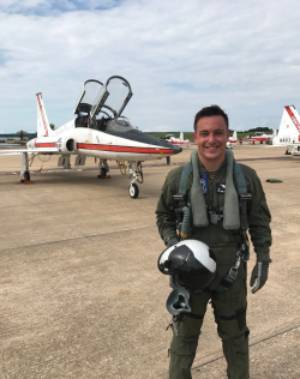 NASA pilot in front of plane.